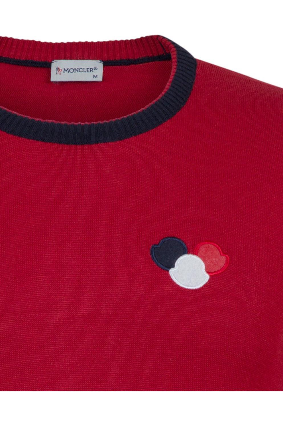 Red Moncler sweater with navy ribbed collar and tri-color logo patch on chest