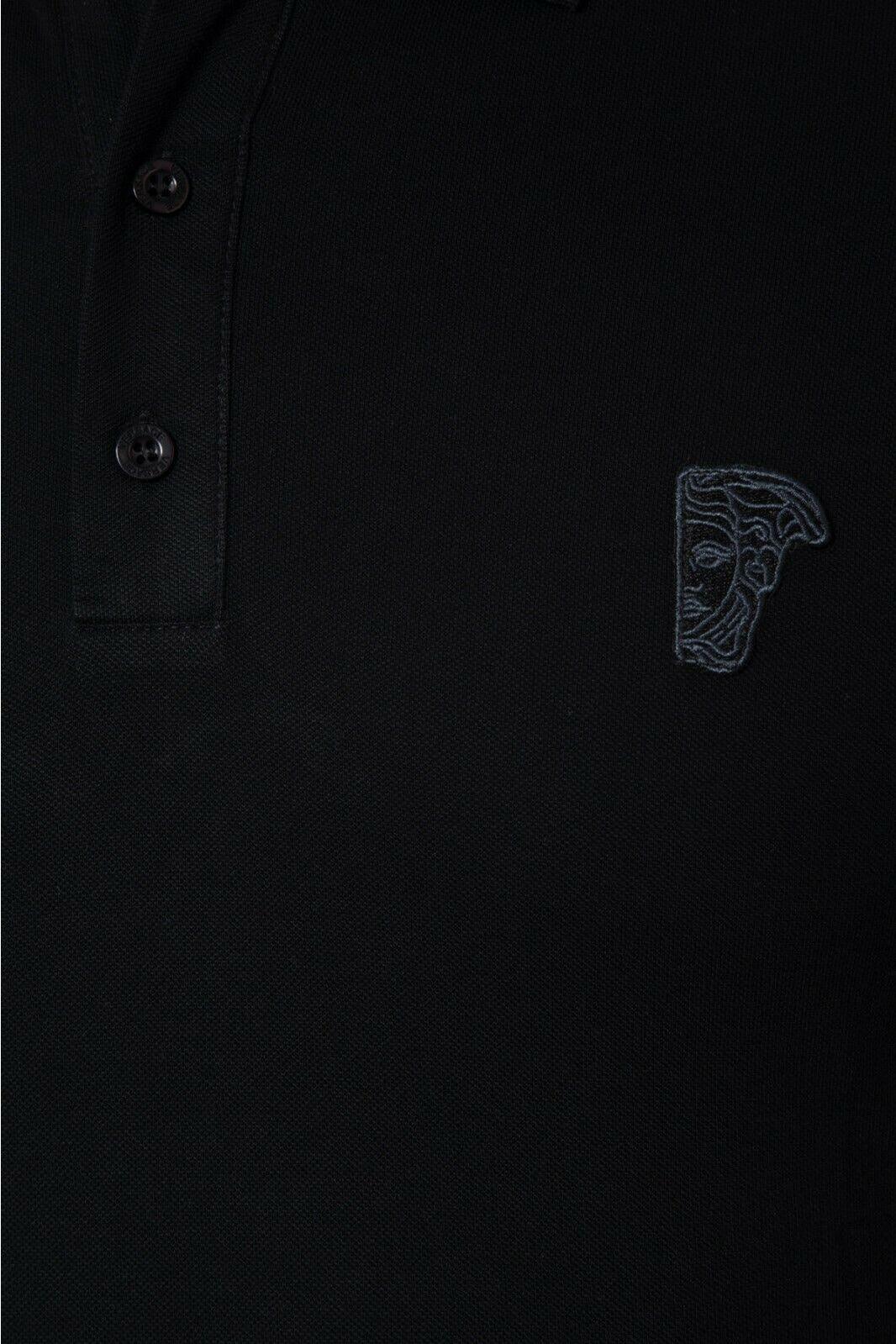 Close-up of black polo shirt with button placket and embroidered Medusa face logo