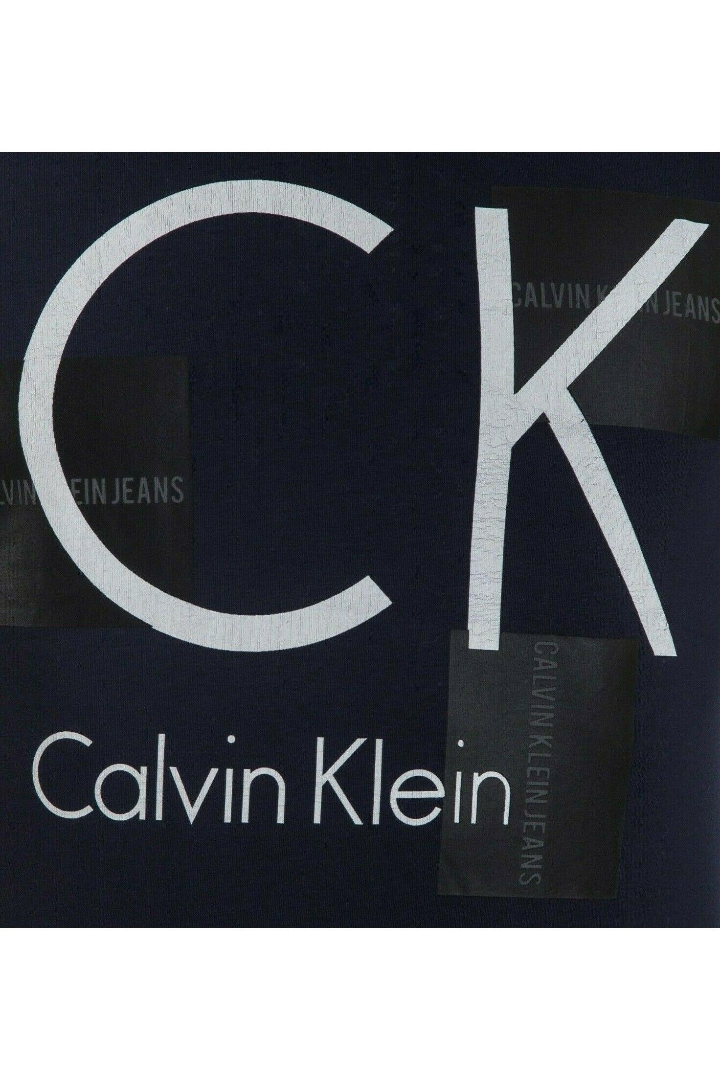 Dark navy fabric with large white CK and Calvin Klein text, black patches with Calvin Klein Jeans text